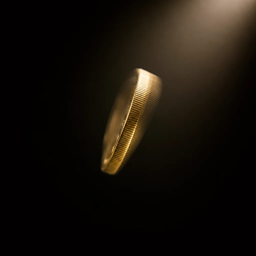 Gold coins cascading over warm beige surface